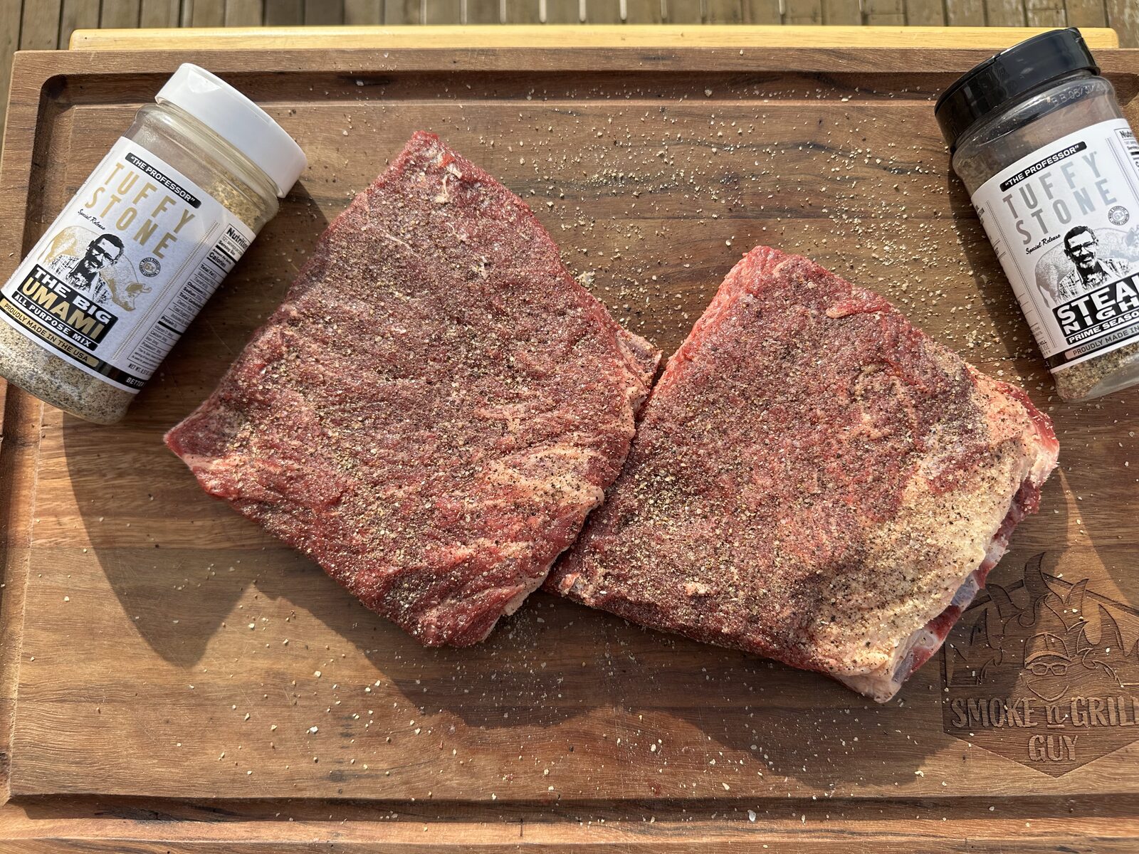 Beef short ribs seasoned with Tuffy Stone Big Umami and Steak Night rubs, with both jars beside them