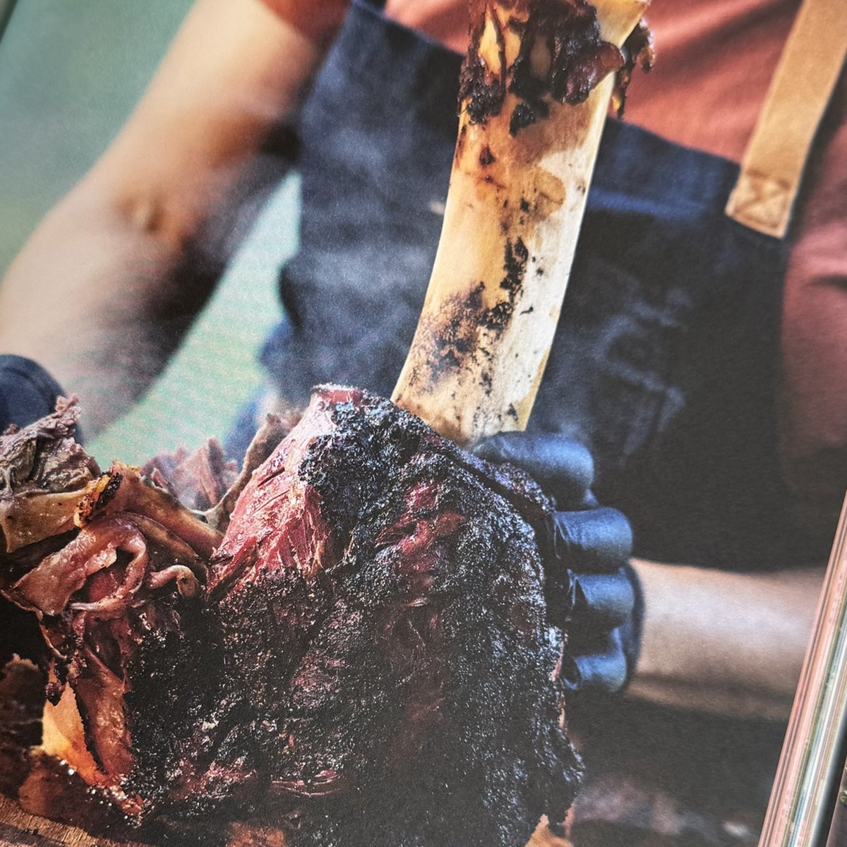 Barbecued beef shank held upright by the bone